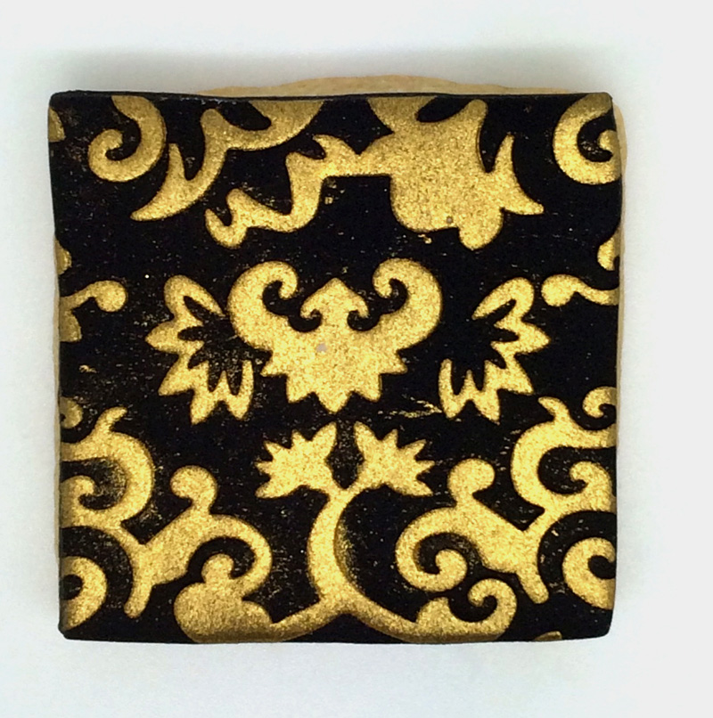glitzerkeks quadrat schwarz mit goldenen Ornamenten